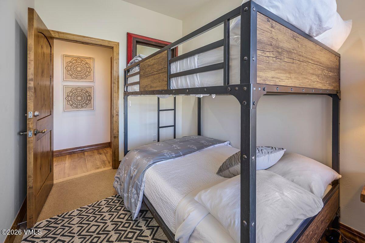 300 Prater Road, Unit A408 Beaver Creek, CO 81620 - Photo 20 of 31 a bedroom with a bed and a window