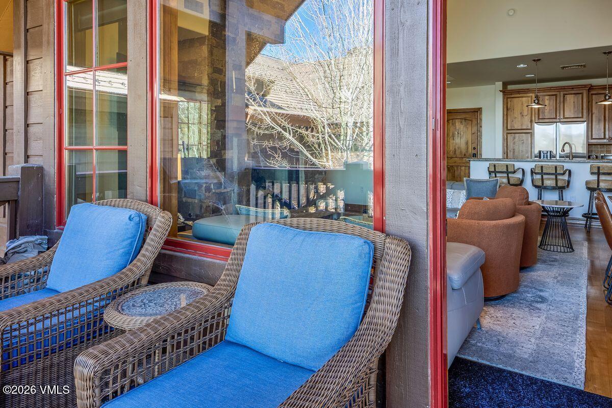 300 Prater Road, Unit A408 Beaver Creek, CO 81620 - Photo 23 of 31 a living room with furniture a lamp and a large window