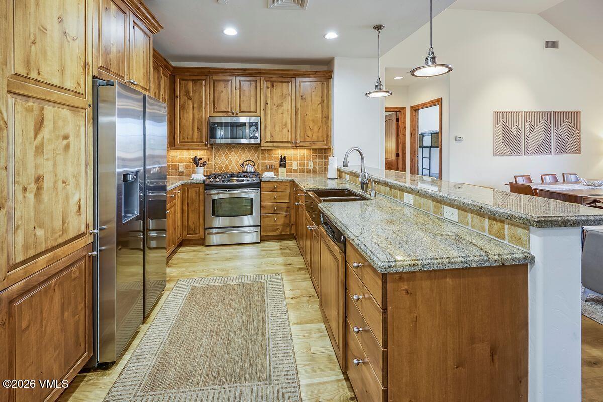 300 Prater Road, Unit A408 Beaver Creek, CO 81620 - Photo 6 of 31 a kitchen with a stove a refrigerator and a sink