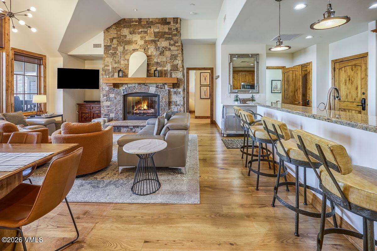 300 Prater Road, Unit A408 Beaver Creek, CO 81620 - Photo 10 of 31 a living room with furniture a fireplace and a flat screen tv