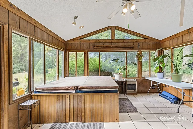 a room with pool table and windows