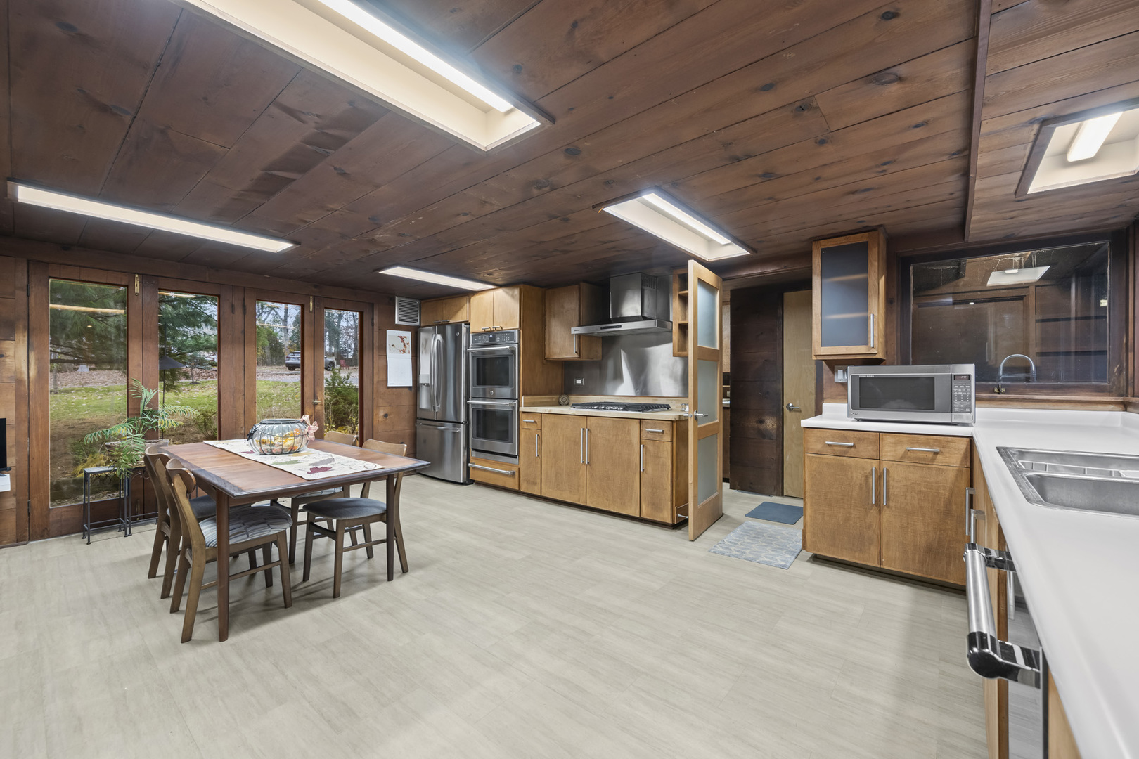 2345 North McAree Road Waukegan, IL 60087 - Photo 17 of 40 a kitchen with a table chairs and a refrigerator