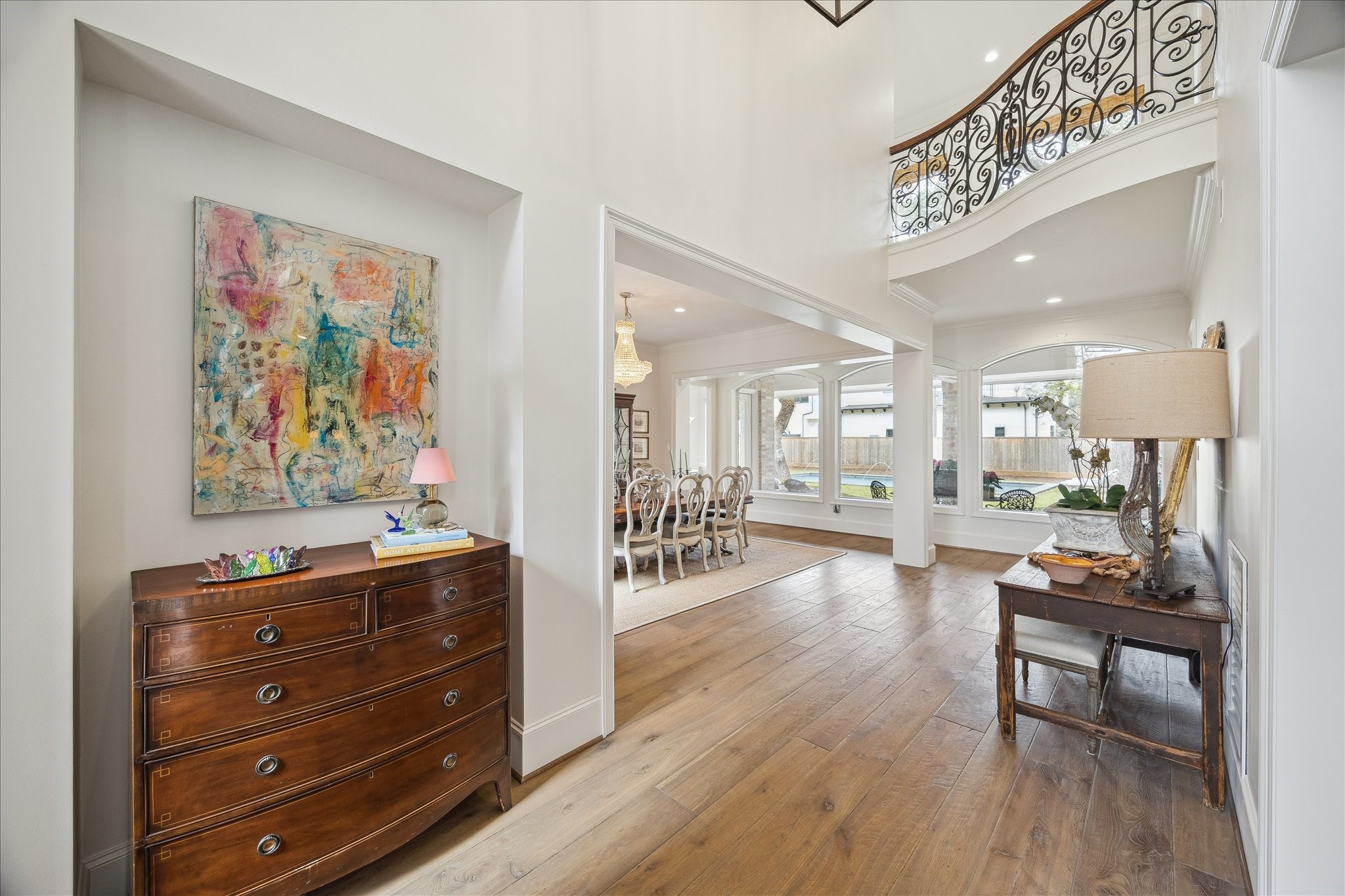 11524 Taylorcrest Road Houston, TX 77024 - Photo 11 of 47 The double-height entry showcases the wood flooring that runs throughout the home. All wood floors were custom installed, milled, and stained by Custom Floors Unlimited in 2024. The French oak planks, in 7" and 9" widths with long runs, feature a wire-brushed distressed texture and hand-beveled edges that create an aged European look.