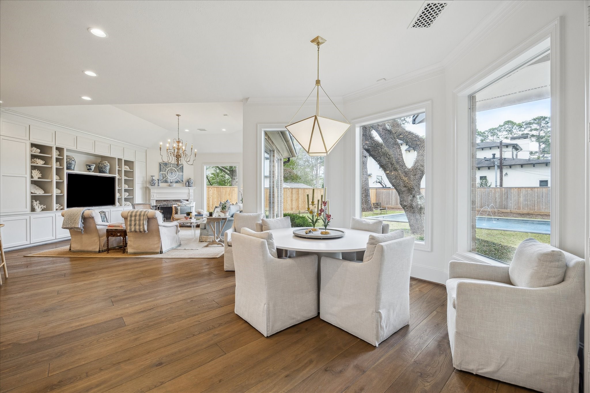 11524 Taylorcrest Road Houston, TX 77024 - Photo 17 of 47 The bright breakfast room features a designer light fixtures and opens to the kitchen and family room, offering panoramic views of the backyard, pool, and mature oak trees.