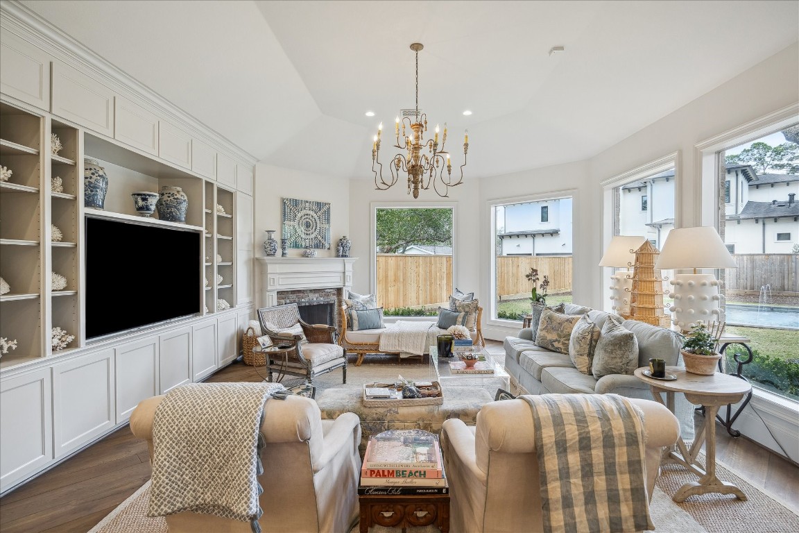 11524 Taylorcrest Road Houston, TX 77024 - Photo 2 of 47 The family room features a wood-burning fireplace with old Chicago brick surround and a wall of built-in shelves and cabinetry offering panoramic views of the backyard.