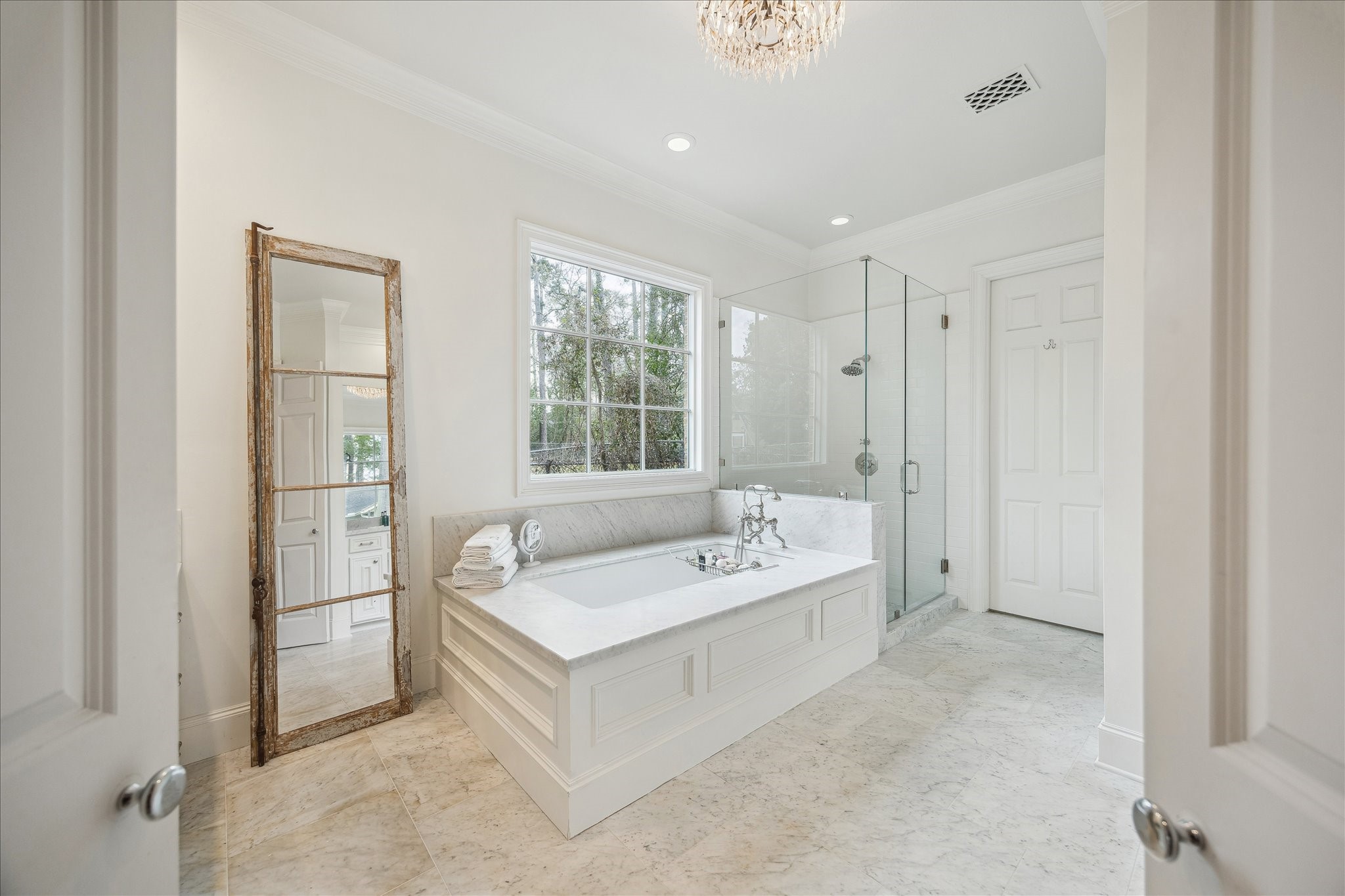 11524 Taylorcrest Road Houston, TX 77024 - Photo 28 of 47 The bathroom features marble floors and honed marble counters with Restoration Hardware square sinks and RH polished nickel faucets. Above the bathtub, a custom nine-pane glass window is framed in marble and paired with a polished nickel Perrin & Rowe traditional exposed deck-mount tub filler with hand shower and cradle. The glass-enclosed shower showcases clean-lined subway tile, Perrin & Rowe polished nickel fixtures, and a rain shower head.