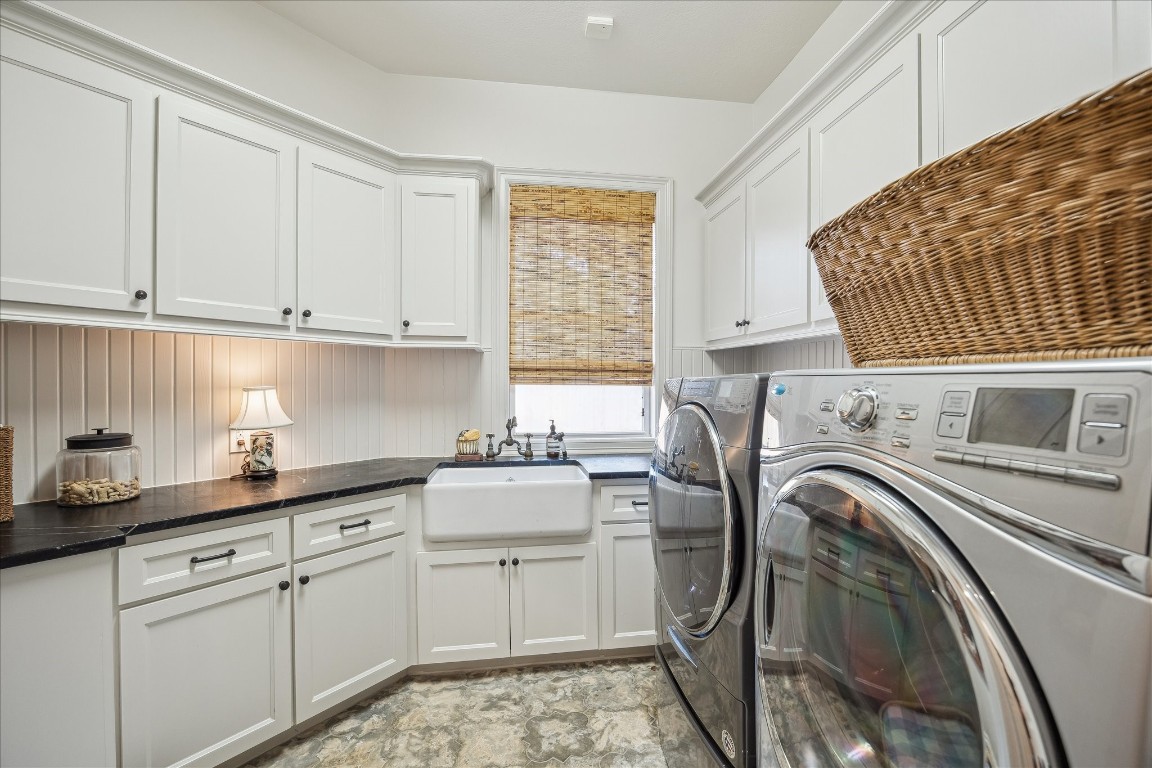 11524 Taylorcrest Road Houston, TX 77024 - Photo 40 of 47 The laundry room features soapstone counters, beadboard walls, a Shaw farmhouse sink, and an oil rubbed bronze Herbeau faucet. Patterned concrete floor tiles sourced from Los Angeles add character, while a window overlooking the side yard brings in natural light.