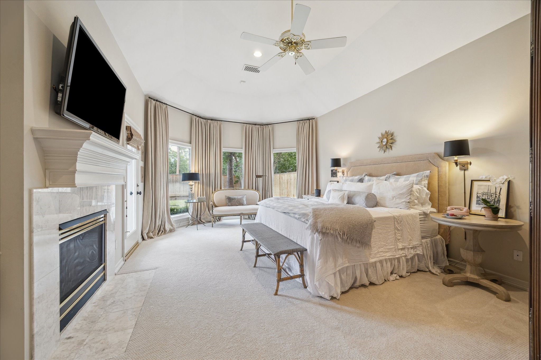 11524 Taylorcrest Road Houston, TX 77024 - Photo 4 of 47 The large first floor primary suite has high ceilings, a gas log fireplace, new carpet, and large windows with views of the back yard and pool.