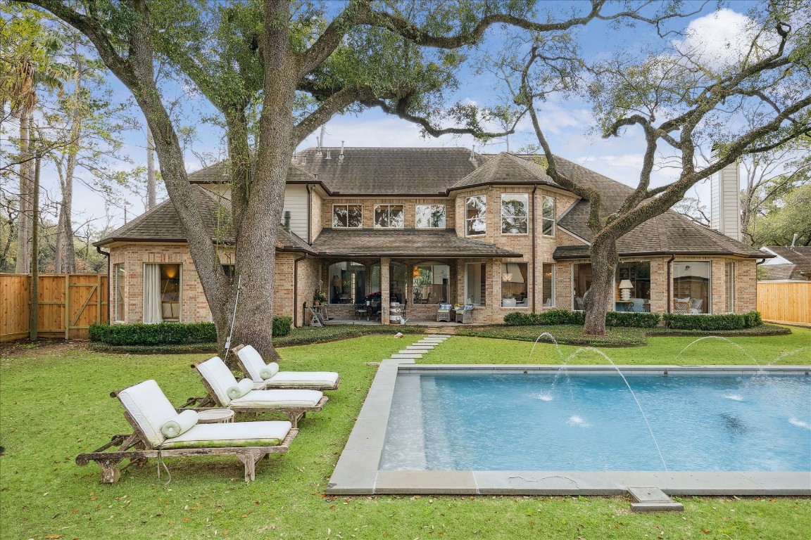 11524 Taylorcrest Road Houston, TX 77024 - Photo 5 of 47 The backyard features a bluestone pool with fountains, mature oaks, and generous green space.