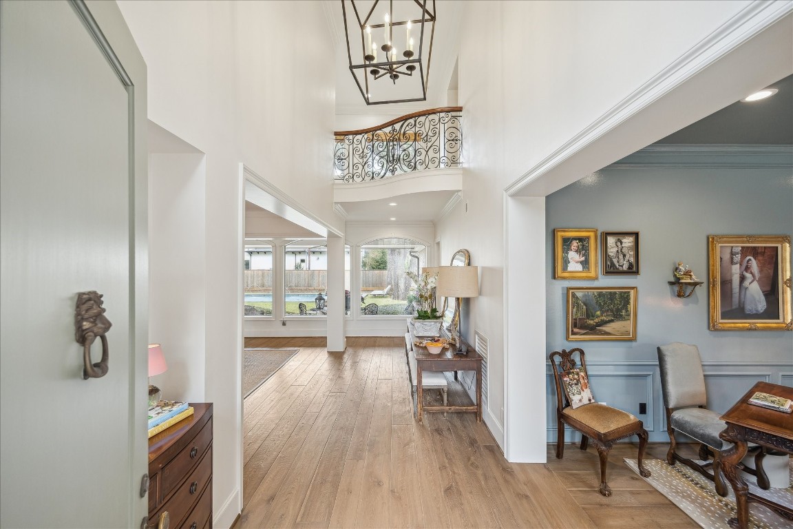 11524 Taylorcrest Road Houston, TX 77024 - Photo 10 of 47 The front entrance opens to a dramatic double-height entry with a wrought iron balcony overlooking the space from the second floor. From the moment you step inside, sightlines extend straight through to the backyard, offering an immediate sense of the home’s expansive lot and bringing the outdoors in.