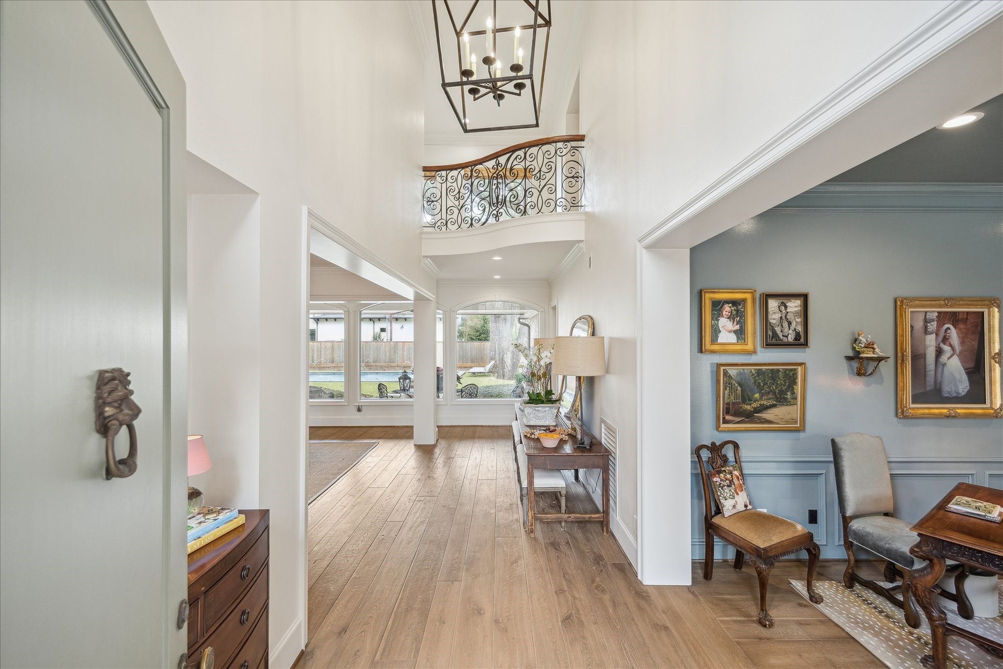 11524 Taylorcrest Road Houston, TX 77024 - Photo 10 of 47 The front entrance opens to a dramatic double-height entry with a wrought iron balcony overlooking the space from the second floor. From the moment you step inside, sightlines extend straight through to the backyard, offering an immediate sense of the home’s expansive lot and bringing the outdoors in.