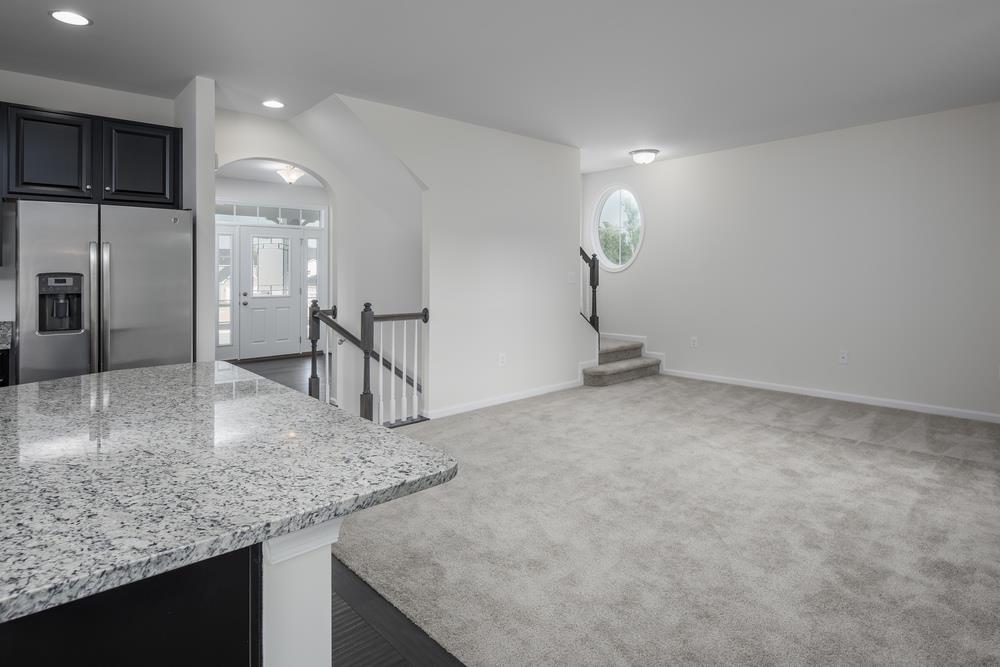 1042 Oglethorpe Drive Franklin, TN 37064 - Photo 9 of 30 a kitchen with kitchen island a counter top space a sink appliances and cabinets