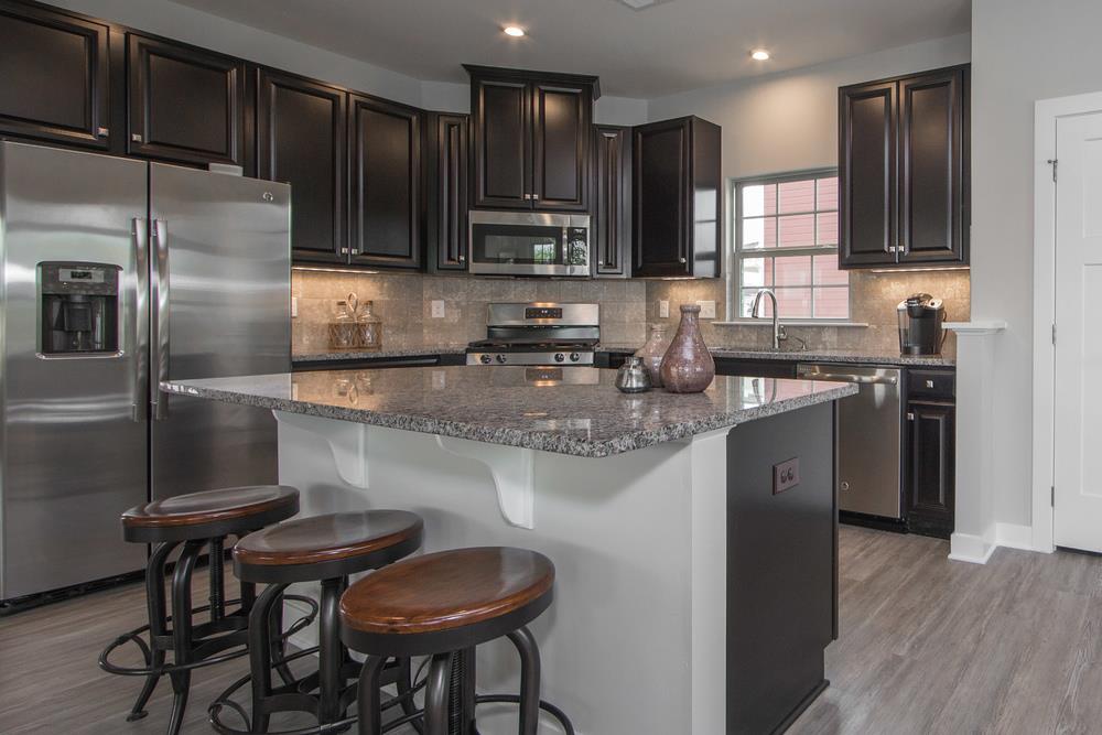 1042 Oglethorpe Drive Franklin, TN 37064 - Photo 13 of 30 a kitchen with stainless steel appliances granite countertop a sink refrigerator and cabinets