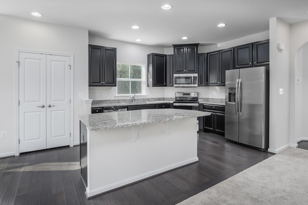 1042 Oglethorpe Drive Franklin, TN 37064 - Photo 3 of 30 a kitchen with stainless steel appliances granite countertop a refrigerator a sink a stove and a refrigerator