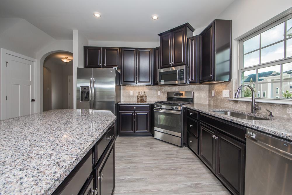 1042 Oglethorpe Drive Franklin, TN 37064 - Photo 6 of 30 a kitchen with stainless steel appliances granite countertop granite counter tops refrigerator a stove and a sink