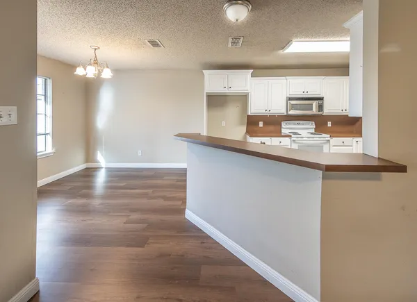 a view of a kitchen from the hallway
