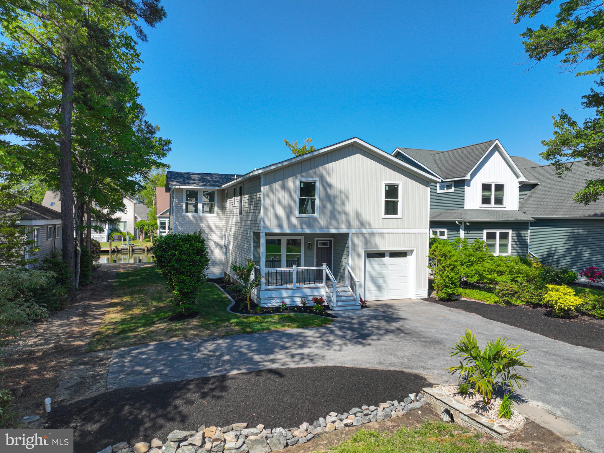 8 Grand Port Road Ocean Pines, MD 21811 - Photo 4 of 18 a front view of a house with a yard and potted plants