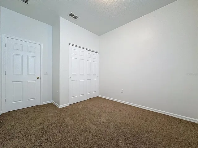 an empty room with closet area