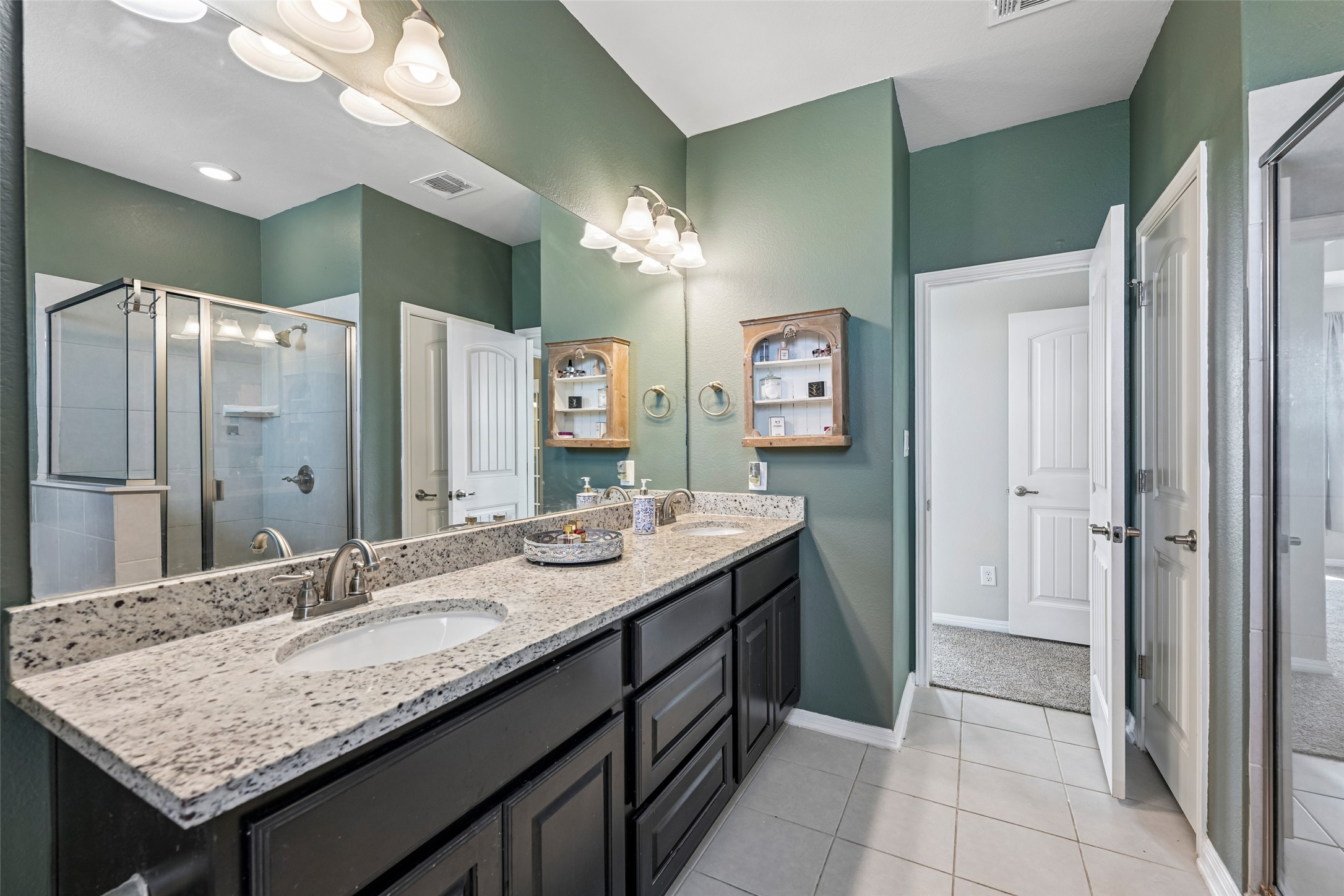 1297 Harwell Loop Kyle, TX 78640 - Photo 23 of 39 Double vanities and a spacious glass-enclosed shower create a rejuvenating bath space.
