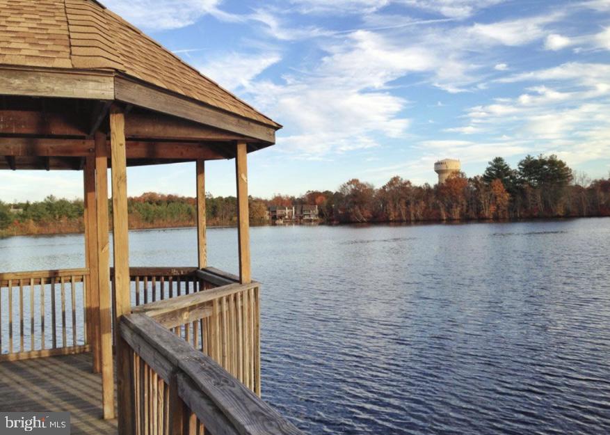 a view of a wooden deck with a lake
