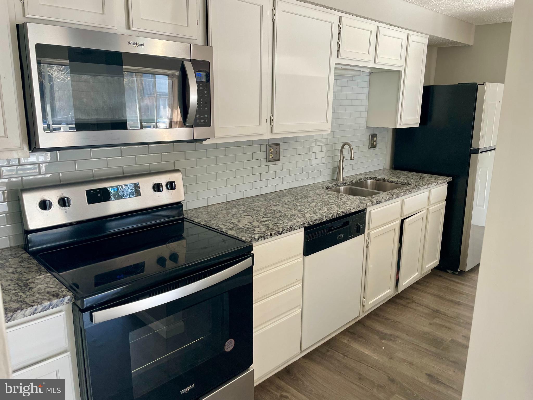 17 Cranberry Court Marlton, NJ 08053 - Photo 8 of 17 a kitchen with a stove and a microwave