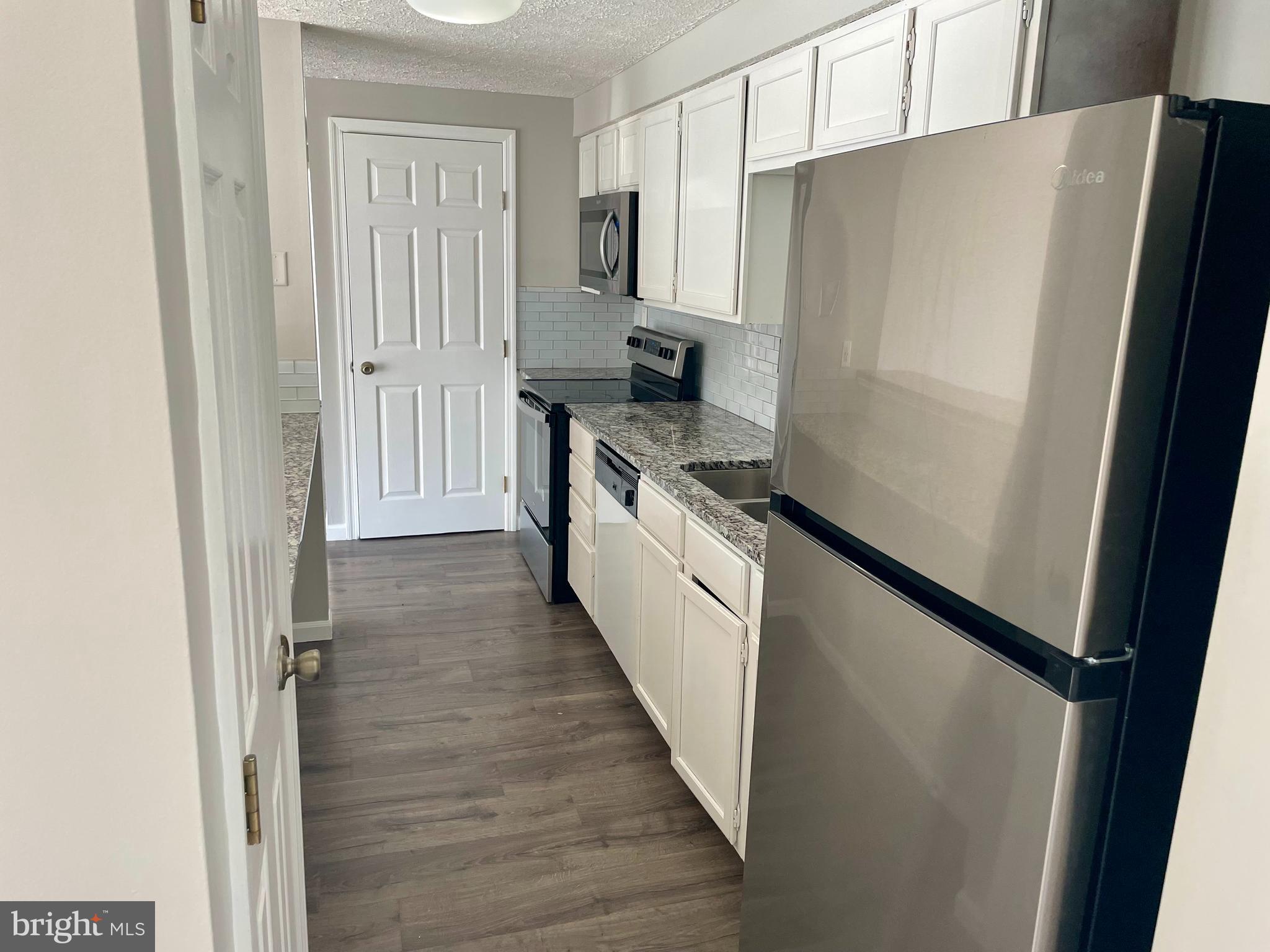 17 Cranberry Court Marlton, NJ 08053 - Photo 9 of 17 a kitchen with a refrigerator and a stove