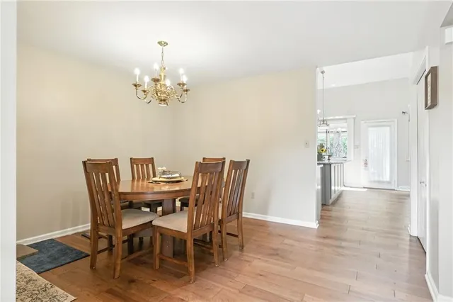 a view of a dining room with furniture and chandelier