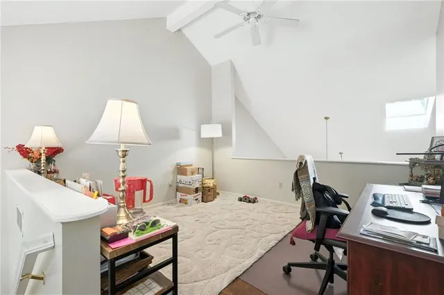 a view of a workspace with furniture and a living room
