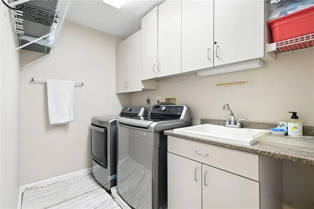a utility room with sink dryer and washer