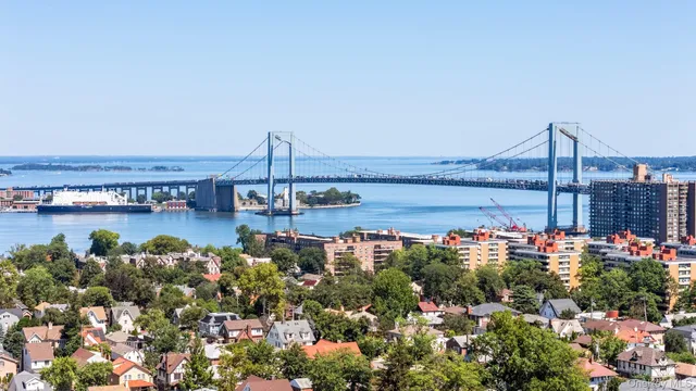 a view of a house with a lake and a building in the background