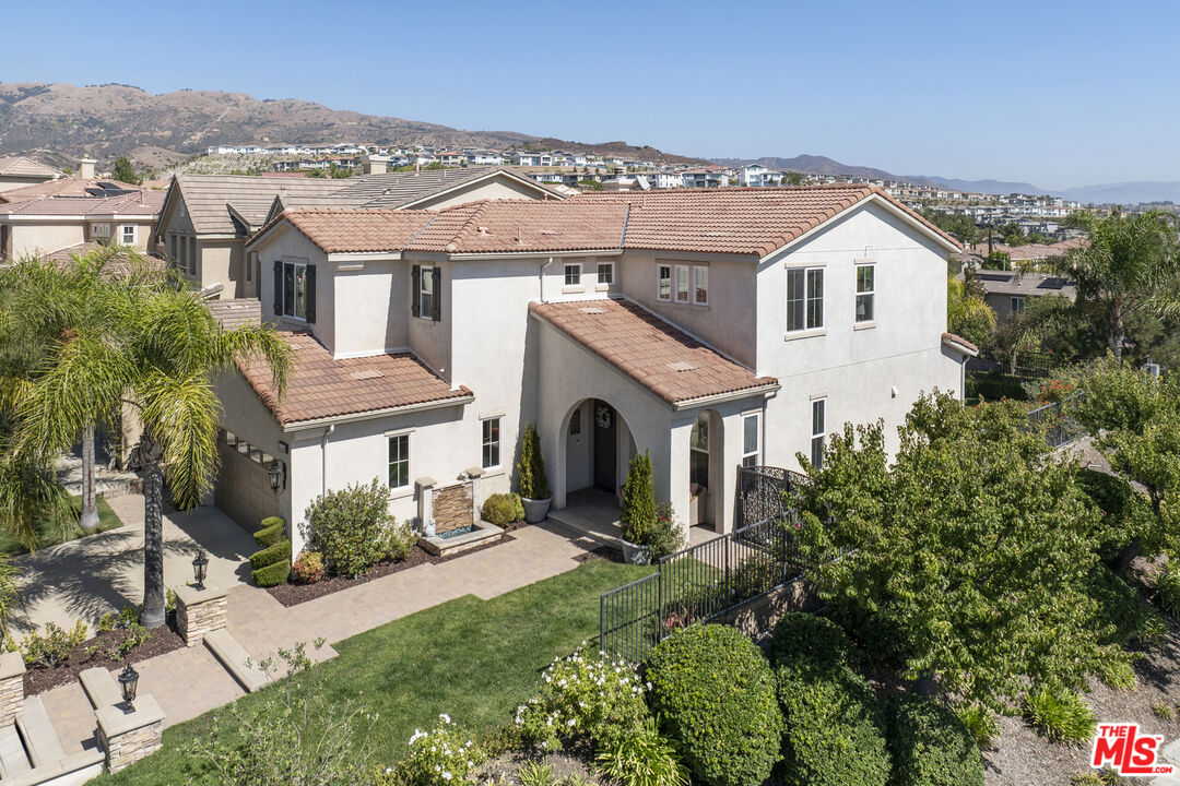 an aerial view of a house with a yard and potted plants