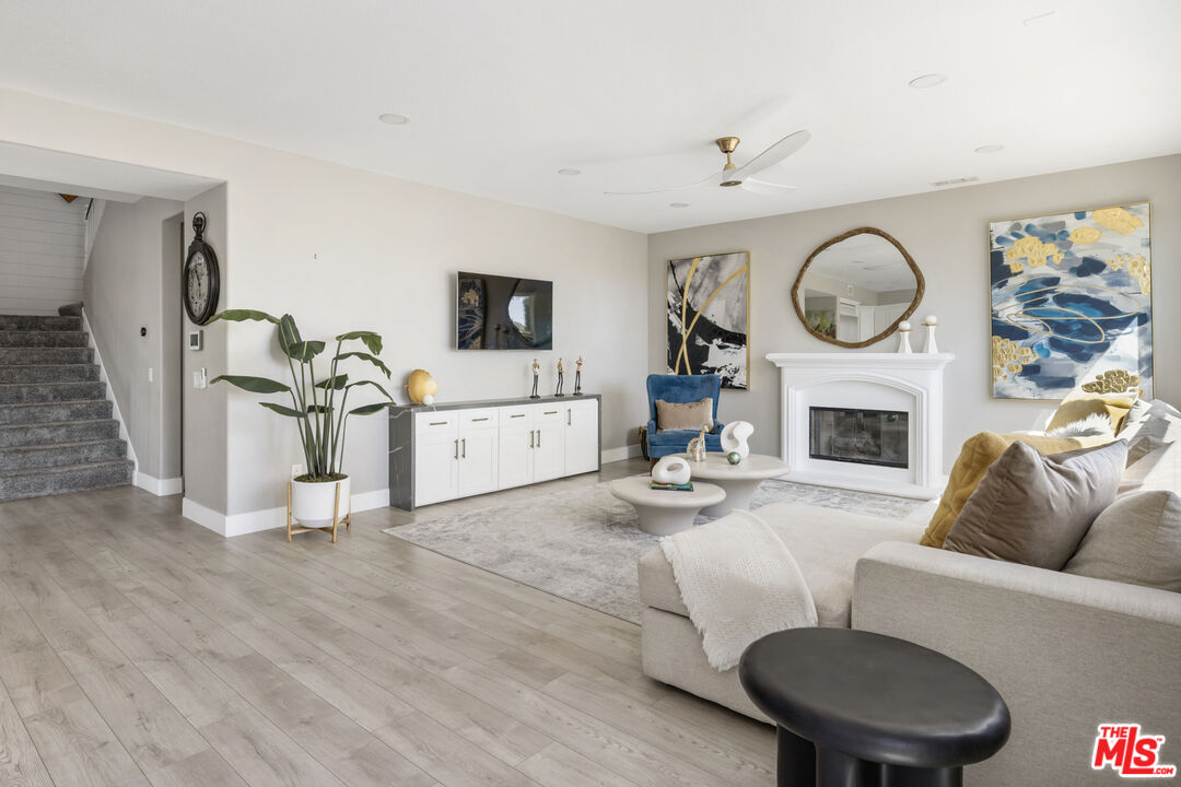 11540 Apulia Court Porter Ranch, CA 91326 - Photo 11 of 25 a living room with furniture a flat screen tv and a fireplace