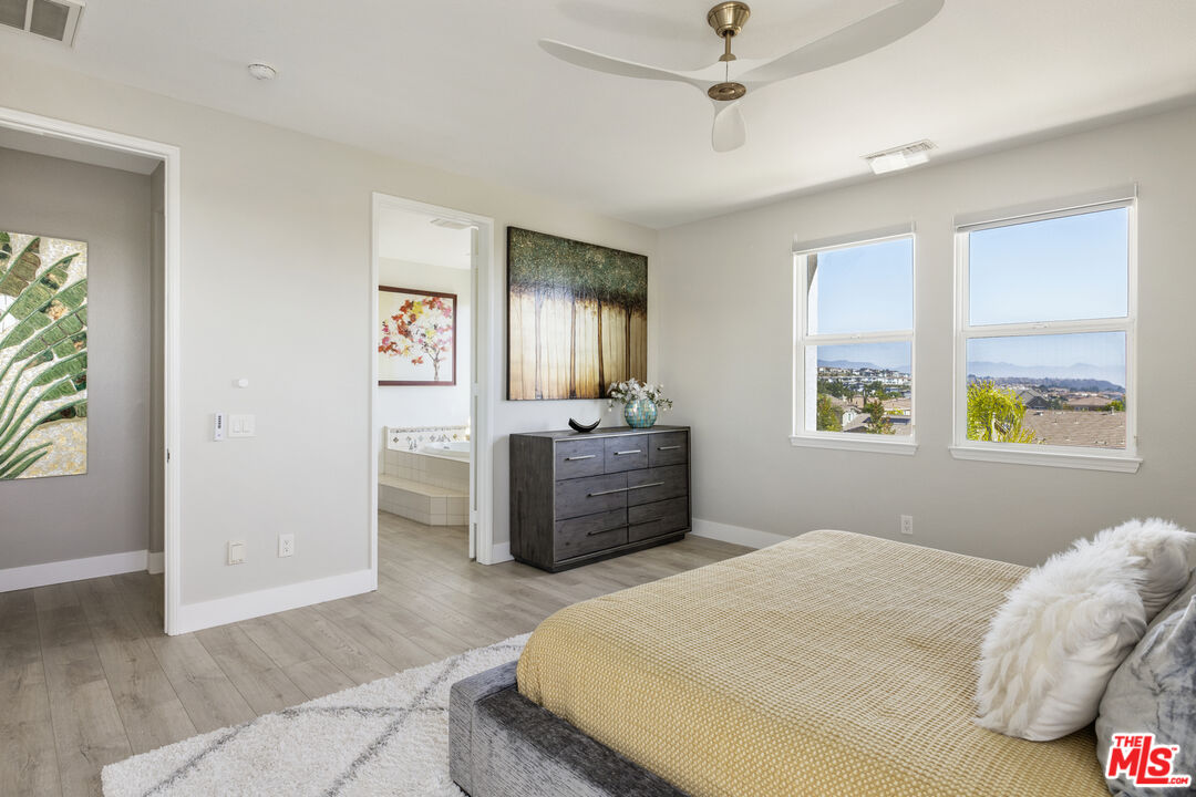 11540 Apulia Court Porter Ranch, CA 91326 - Photo 14 of 25 a bedroom with a bed and a chandelier