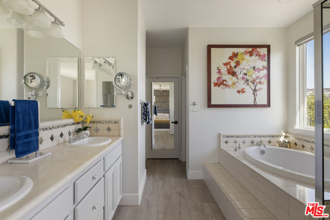 11540 Apulia Court Porter Ranch, CA 91326 - Photo 15 of 25 a bathroom with a bathtub a sink and a mirror