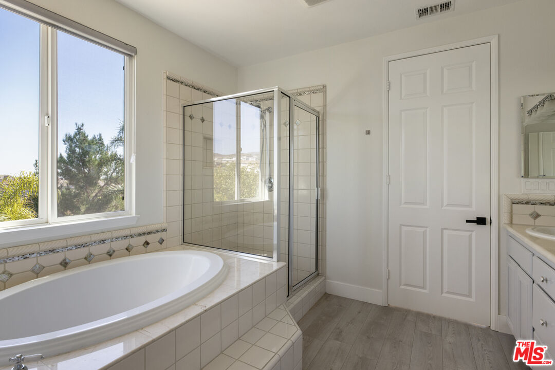 11540 Apulia Court Porter Ranch, CA 91326 - Photo 16 of 25 a bathroom with a bathtub and shower