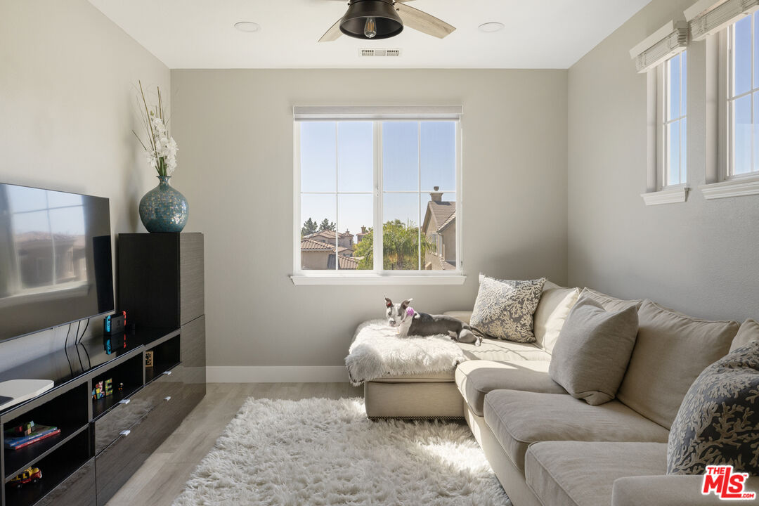 11540 Apulia Court Porter Ranch, CA 91326 - Photo 17 of 25 a living room with furniture and a flat screen tv