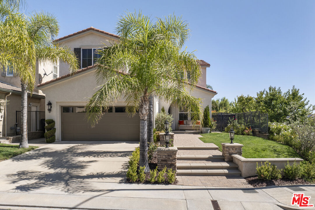 11540 Apulia Court Porter Ranch, CA 91326 - Photo 2 of 25 a front view of a house with a yard
