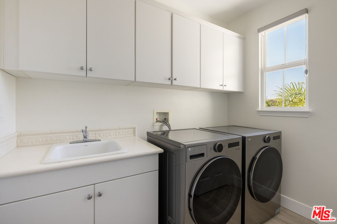 11540 Apulia Court Porter Ranch, CA 91326 - Photo 21 of 25 a utility room with sink dryer and washer