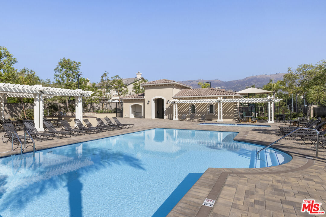 11540 Apulia Court Porter Ranch, CA 91326 - Photo 24 of 25 a front view of house with yard and swimming pool
