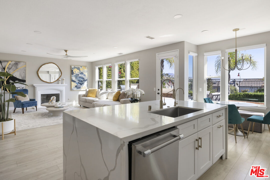 11540 Apulia Court Porter Ranch, CA 91326 - Photo 7 of 25 a open kitchen with stainless steel appliances granite countertop a sink and a large window