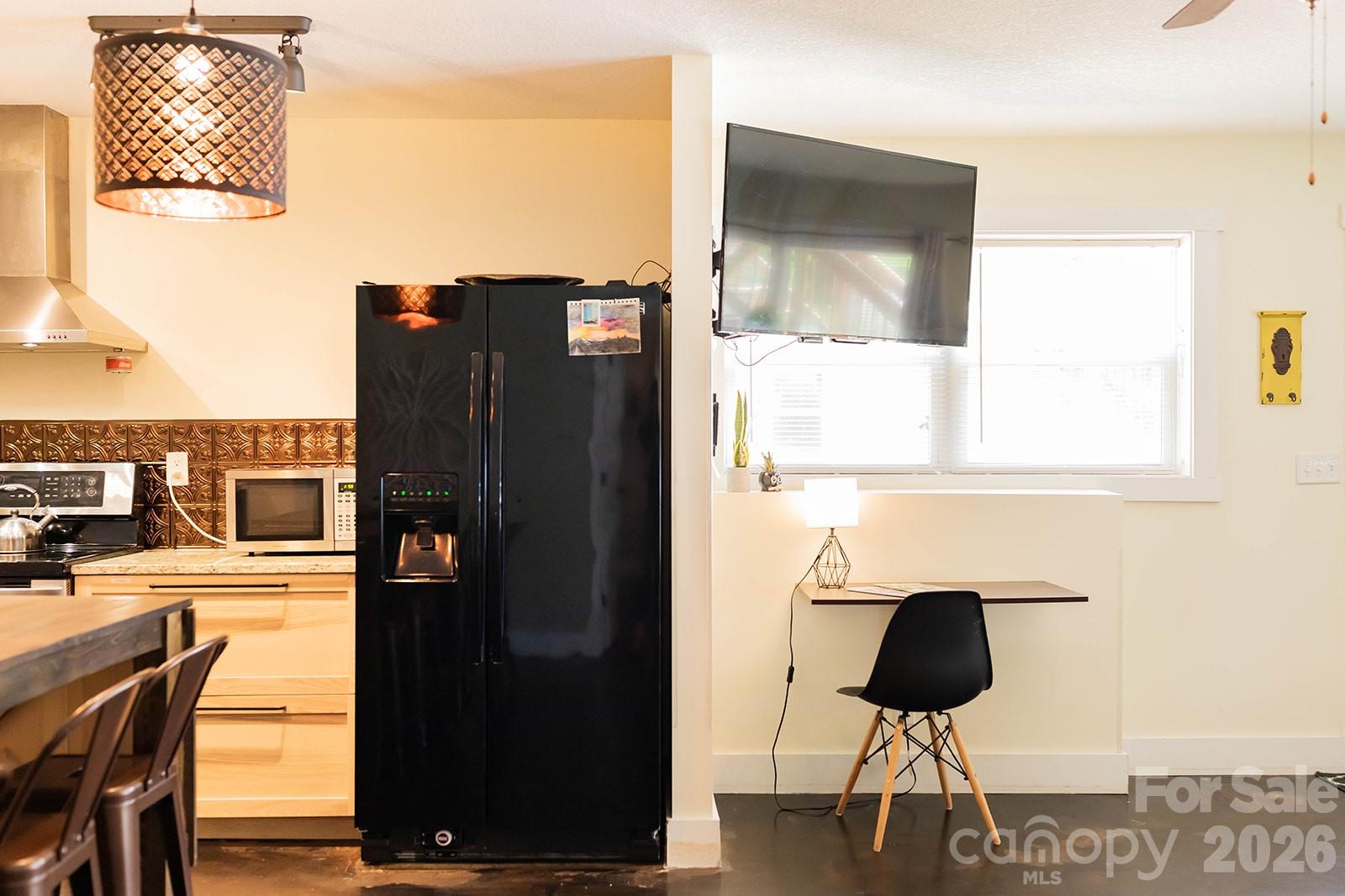 309 London Road Asheville, NC 28803 - Photo 18 of 41 a kitchen with a refrigerator and cabinets