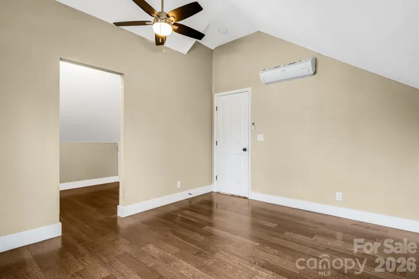 a view of a room with wooden floor