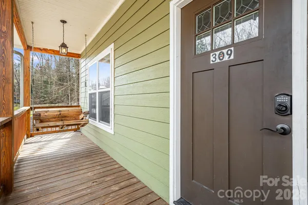 a view of a balcony with wooden floor and furniture