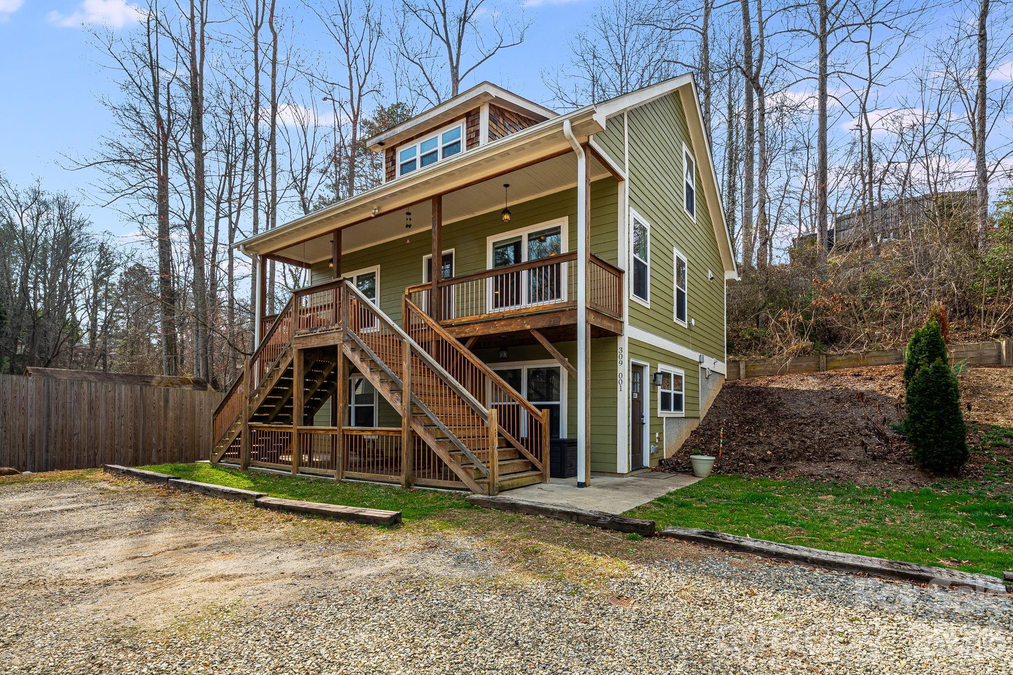 309 London Road Asheville, NC 28803 - Photo 41 of 41 a view of a house with wooden deck next to a yard