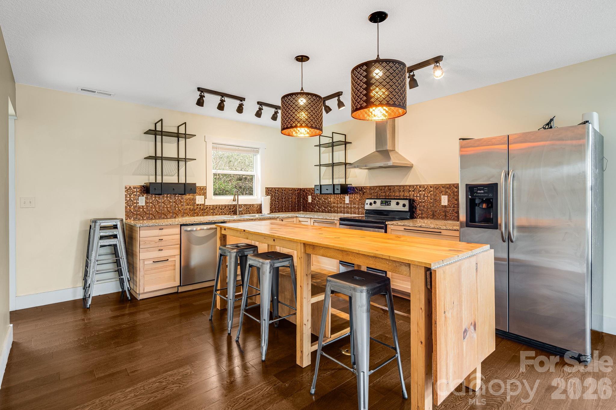 309 London Road Asheville, NC 28803 - Photo 5 of 41 a kitchen with stainless steel appliances granite countertop a stove and a refrigerator