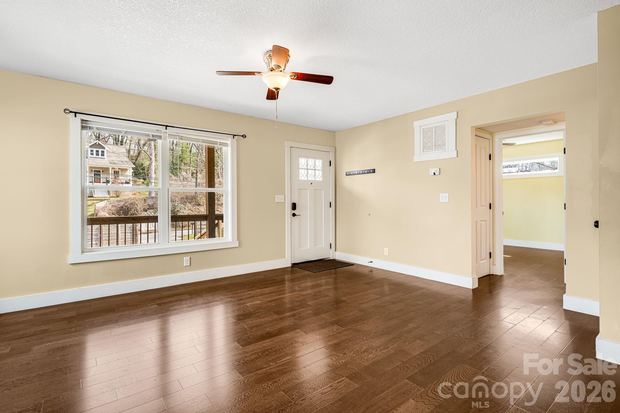 309 London Road Asheville, NC 28803 - Photo 10 of 41 a view of an empty room with wooden floor and a window