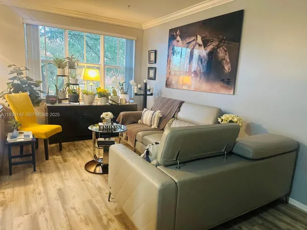 a living room with furniture and a large window