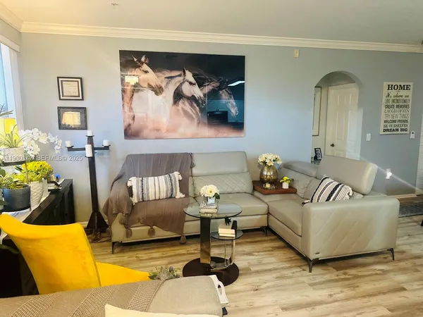 a living room with furniture and painting on the wall