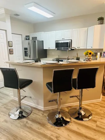 a kitchen with stainless steel appliances kitchen island granite countertop a sink counter space and cabinets