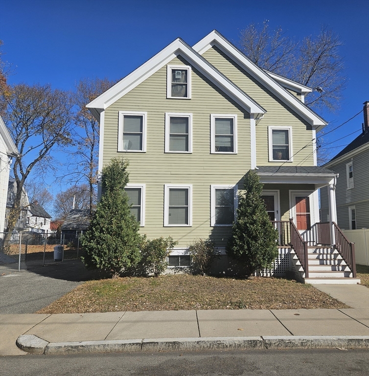 20 Massasoit Street Boston, MA 02136 - Photo 18 of 18 a front view of a house with a yard and garage